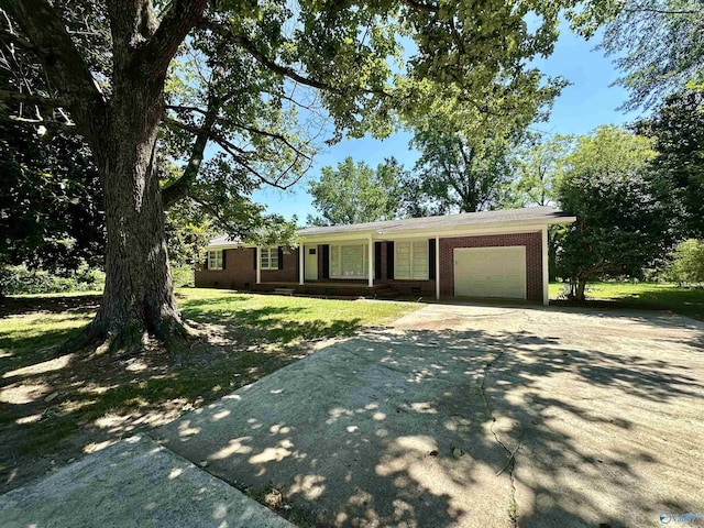 ranch-style house featuring a garage and a front lawn