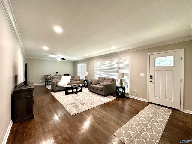 living room with dark wood-type flooring, plenty of natural light, and crown molding