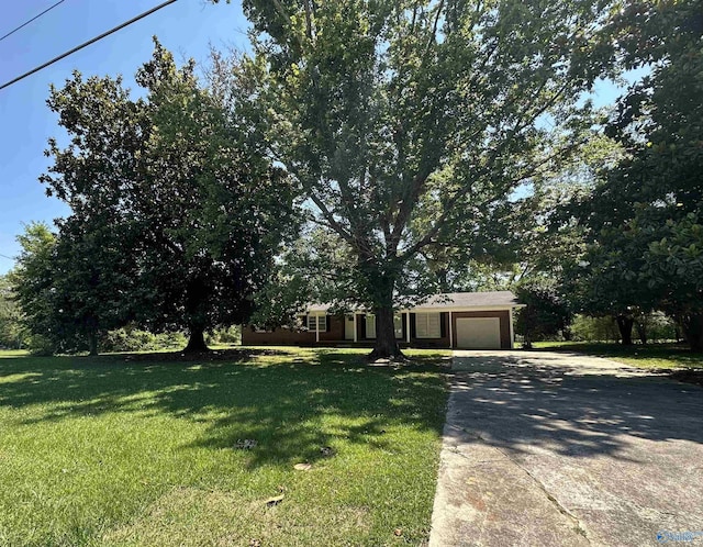 view of front of home featuring a garage and a front lawn