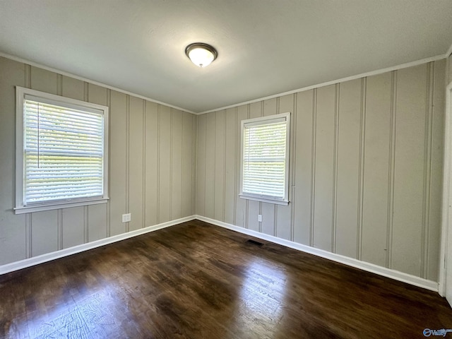 unfurnished room with dark hardwood / wood-style floors