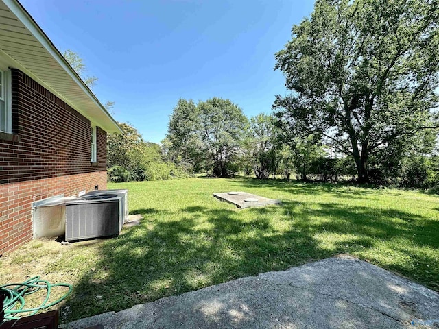 view of yard featuring central air condition unit