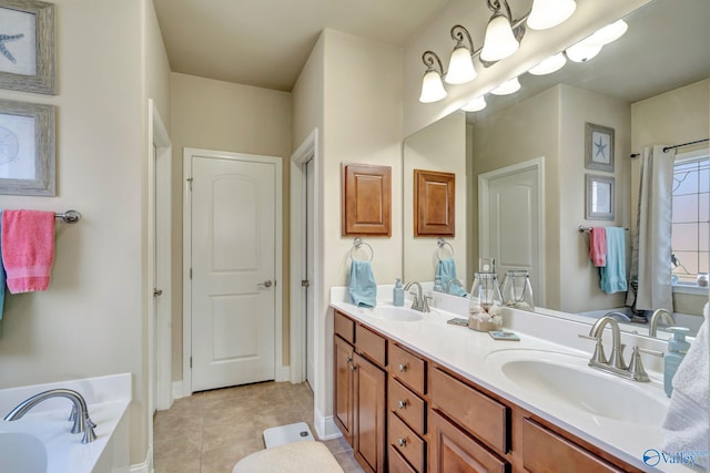 bathroom with double vanity, a tub, a sink, and tile patterned floors