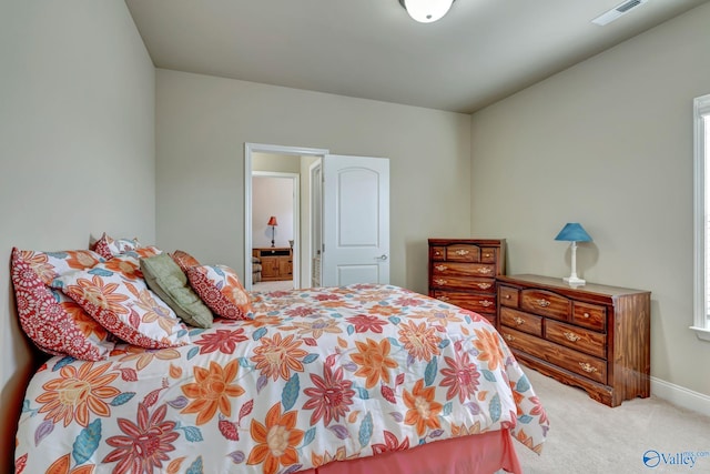 carpeted bedroom with visible vents and baseboards