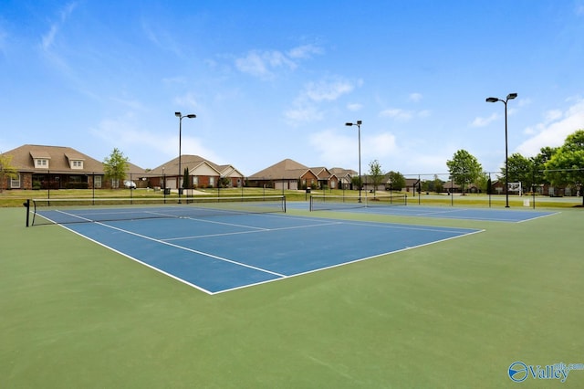 view of tennis court with fence