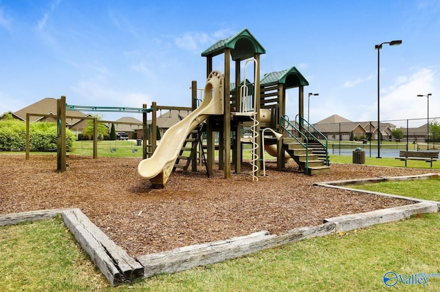 communal playground featuring fence