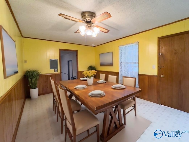 dining area with a textured ceiling and ceiling fan