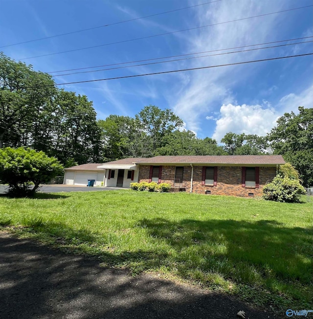 single story home featuring a garage and a front lawn