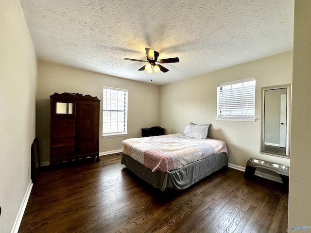 bedroom featuring a textured ceiling, wood finished floors, a ceiling fan, and baseboards