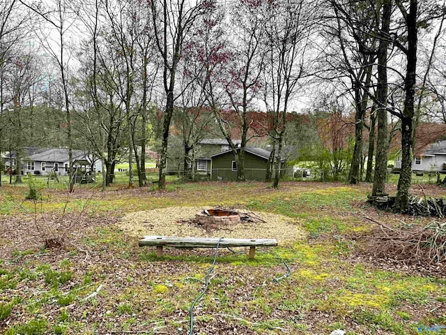 view of yard featuring an outdoor fire pit