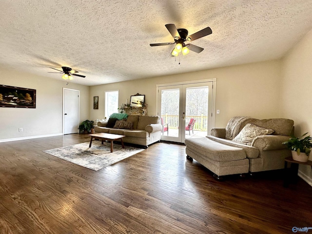 living room featuring a textured ceiling, dark wood-type flooring, french doors, and ceiling fan