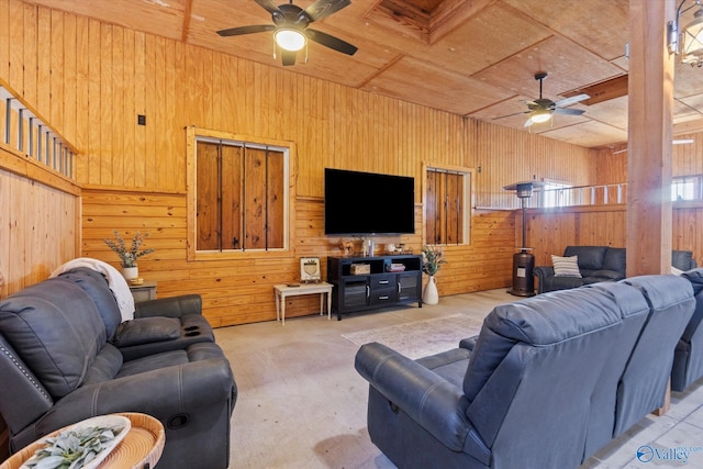 living room with wooden walls, wooden ceiling, and ceiling fan