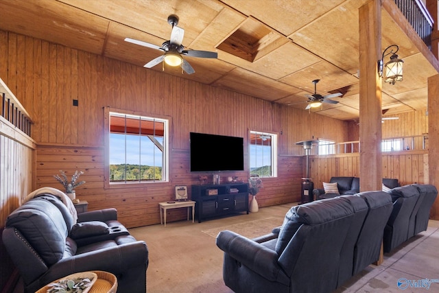 living room featuring wood ceiling, light carpet, ceiling fan, and wood walls