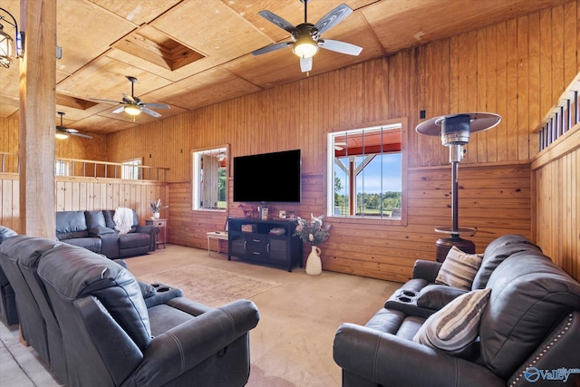 living room with wood ceiling, wood walls, light colored carpet, and ceiling fan