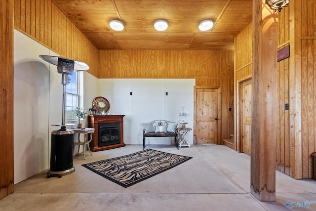 interior space with wood ceiling, wood walls, and a high ceiling