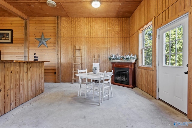 dining space featuring wooden walls and wood ceiling