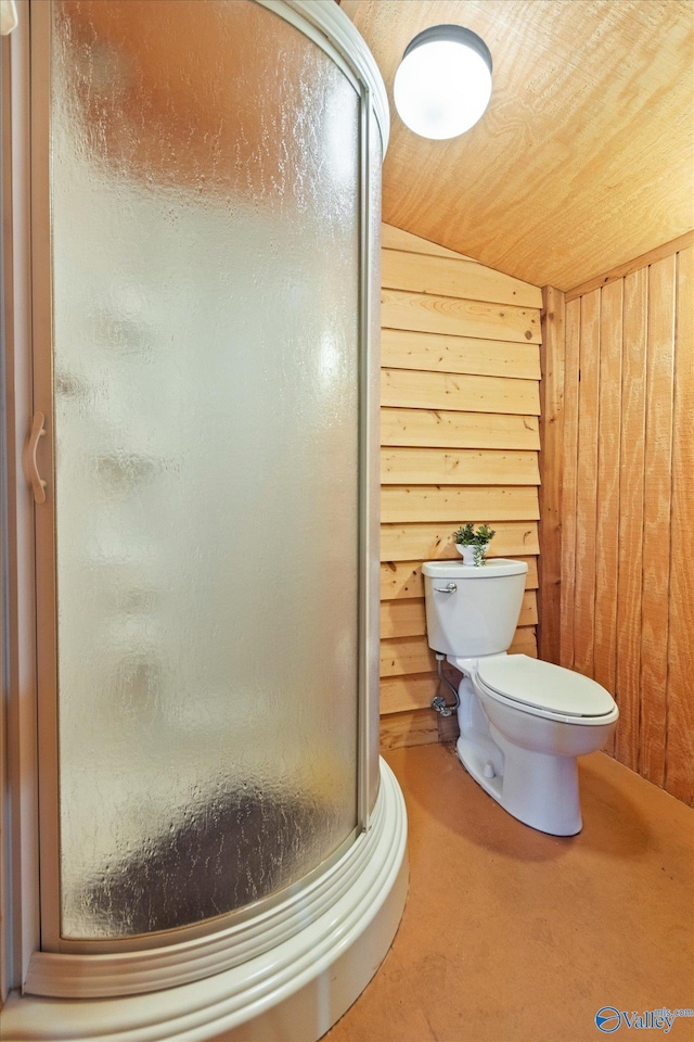 bathroom with a shower with door, wood walls, toilet, and vaulted ceiling