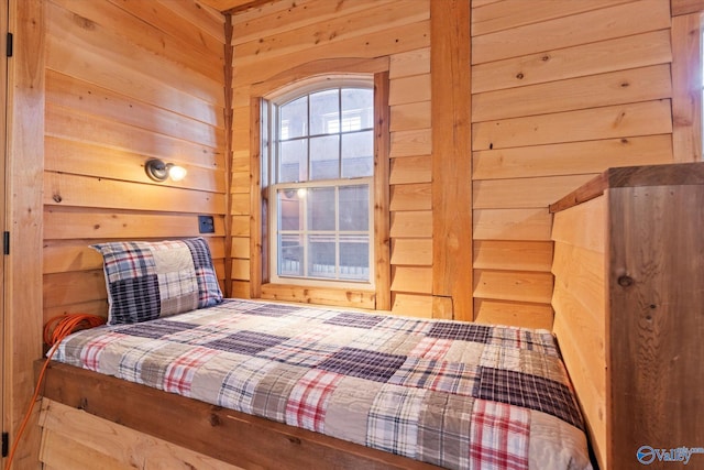 bedroom featuring wooden walls