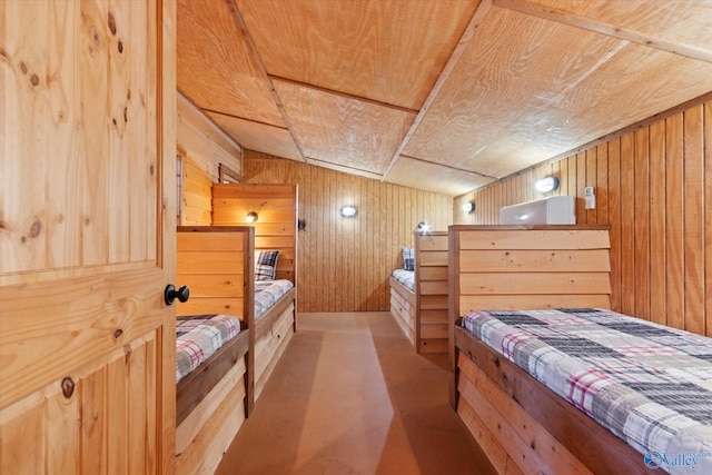 bedroom with lofted ceiling, wooden walls, and wooden ceiling