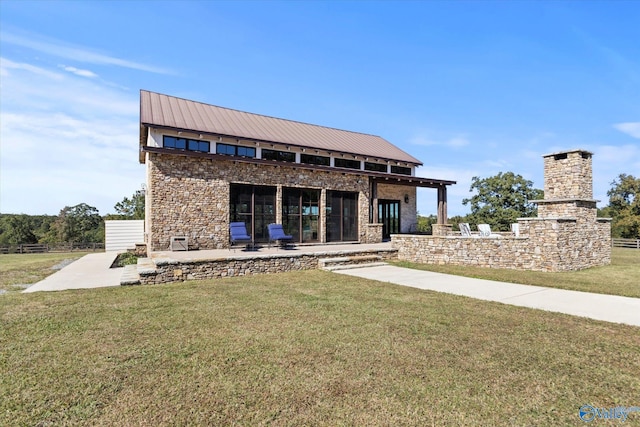 rear view of house with a patio area and a lawn