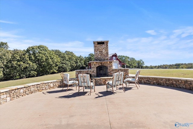 view of patio featuring an outdoor stone fireplace