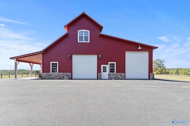 view of property exterior with a carport and a garage