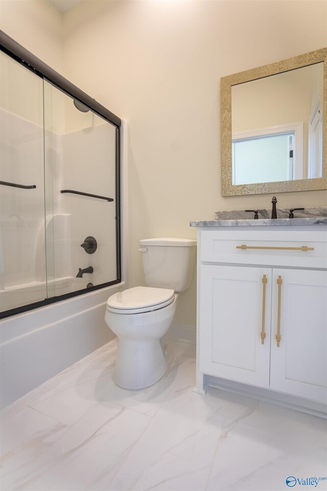 full bathroom with vanity, enclosed tub / shower combo, and toilet