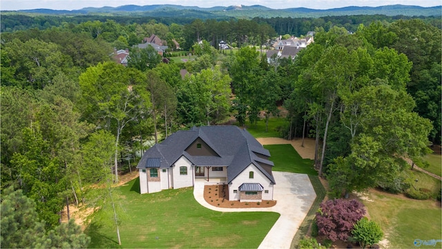 bird's eye view with a forest view and a mountain view