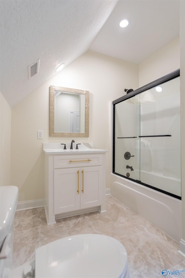 full bathroom with a textured ceiling, vanity, lofted ceiling, and bath / shower combo with glass door