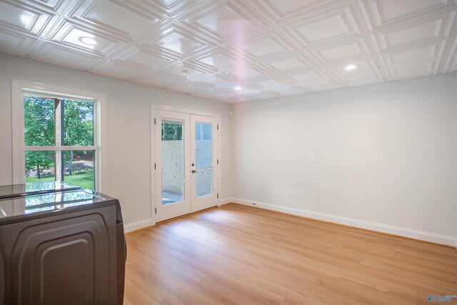 interior space featuring washer / clothes dryer, french doors, and light wood-type flooring