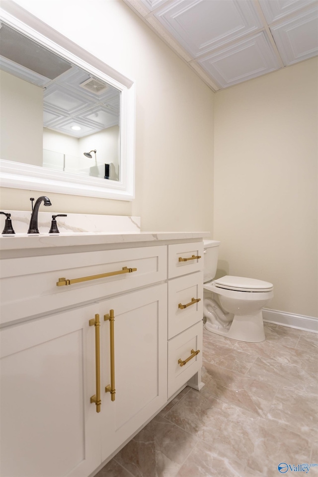 bathroom with tile patterned floors, vanity, and toilet