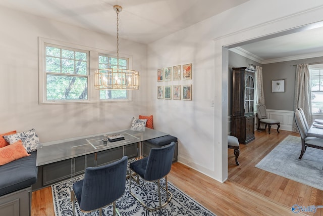 office featuring wainscoting, light wood-type flooring, and ornamental molding