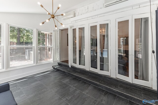 unfurnished sunroom with french doors, a wall mounted air conditioner, and a chandelier