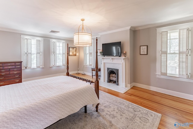 bedroom with crown molding and light hardwood / wood-style flooring