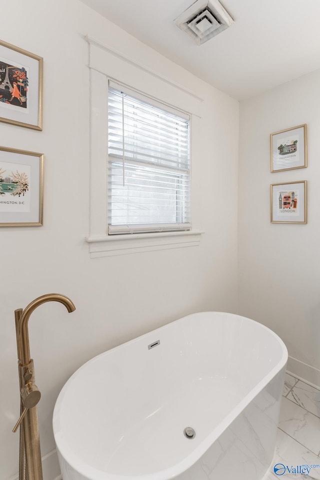 bathroom featuring tile patterned flooring and a bath