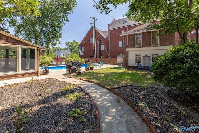 view of yard featuring an outdoor pool and a patio