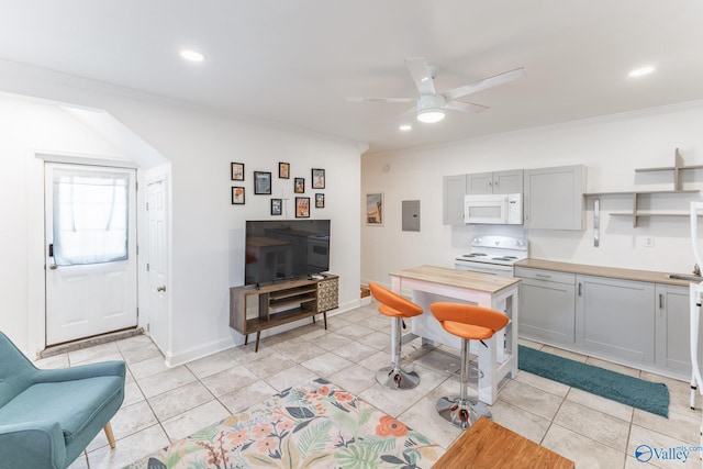 kitchen featuring white appliances, light tile patterned floors, electric panel, gray cabinets, and crown molding