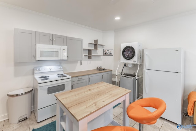 kitchen with ornamental molding, stacked washer and dryer, white appliances, wood counters, and light tile patterned flooring