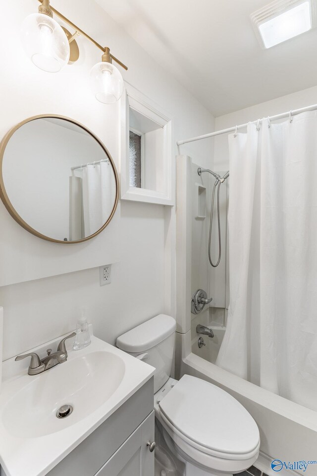 full bathroom featuring toilet, vanity, and shower / bathtub combination with curtain