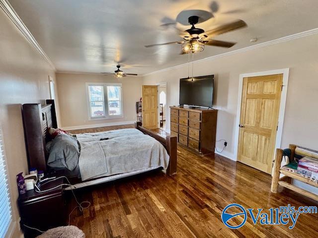 bedroom featuring dark hardwood / wood-style flooring and crown molding