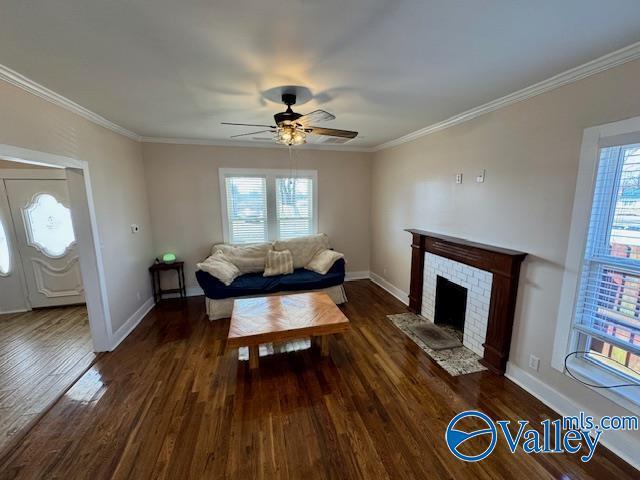 living room with a fireplace, ornamental molding, and dark hardwood / wood-style floors