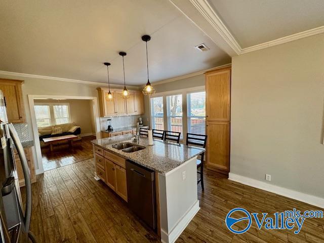 kitchen featuring dark wood-type flooring, stainless steel fridge, a kitchen island with sink, black dishwasher, and light stone countertops