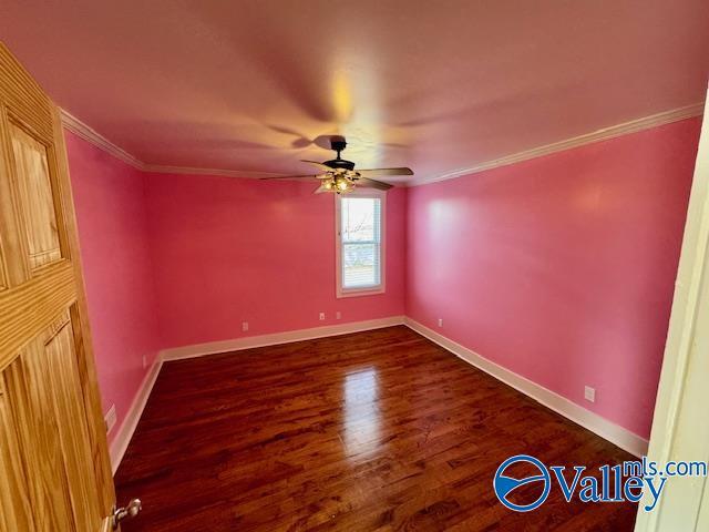 spare room with crown molding, ceiling fan, and dark hardwood / wood-style flooring