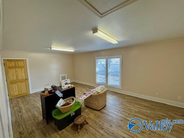 interior space with hardwood / wood-style flooring and ornamental molding