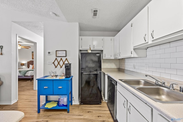 kitchen with white cabinetry, sink, black appliances, and light wood-type flooring