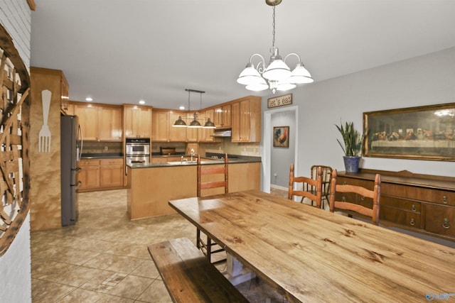 dining area with an inviting chandelier, sink, and light tile patterned floors