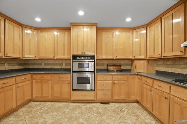 kitchen featuring light tile patterned flooring, backsplash, double oven, and black stovetop