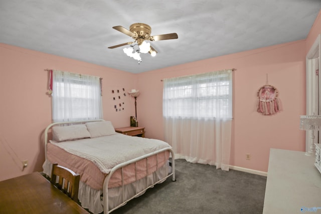 bedroom with ceiling fan and dark carpet