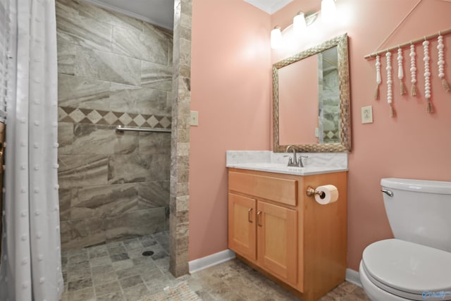 bathroom featuring vanity, toilet, and a tile shower