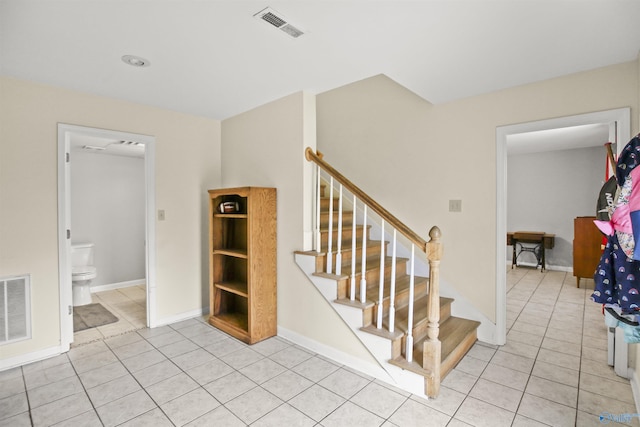 staircase featuring tile patterned floors