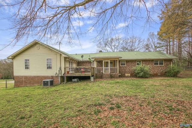 back of house with a wooden deck, central AC, and a lawn